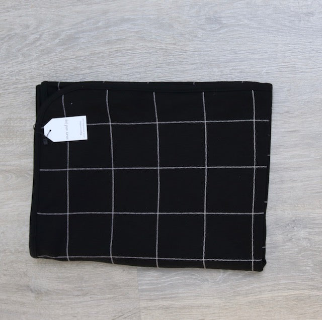 Reversible jersey black check and safari print blanket